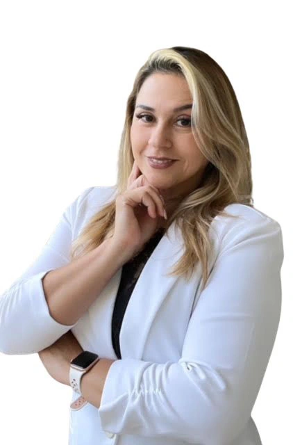 A woman in white jacket posing for the camera.