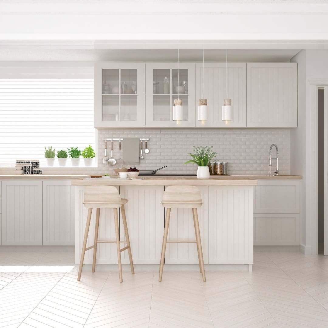 A kitchen with white cabinets and tile floors.