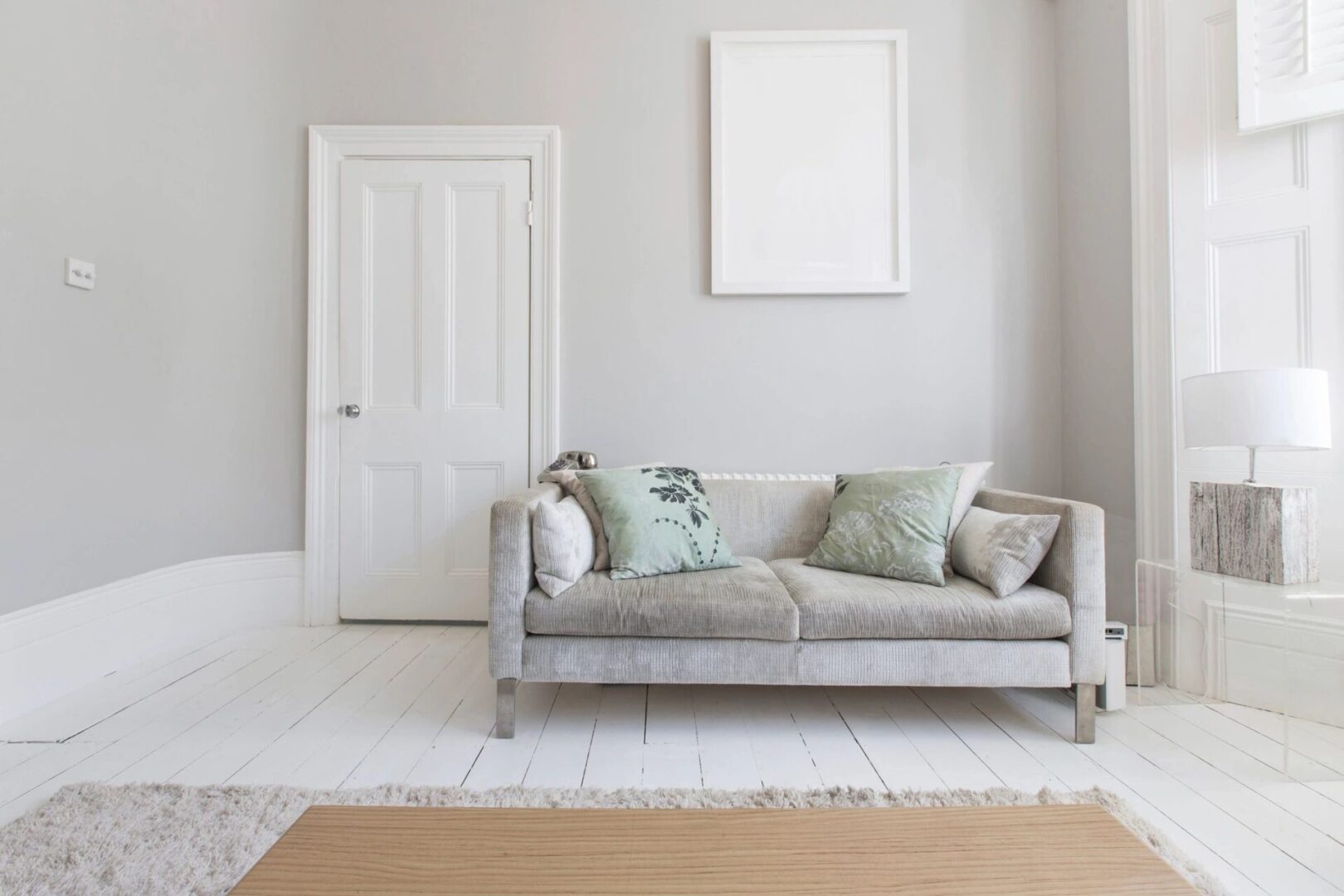 A white room with a couch and rug