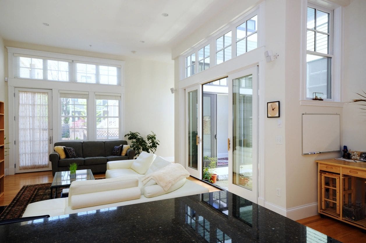 A living room with white furniture and black table.